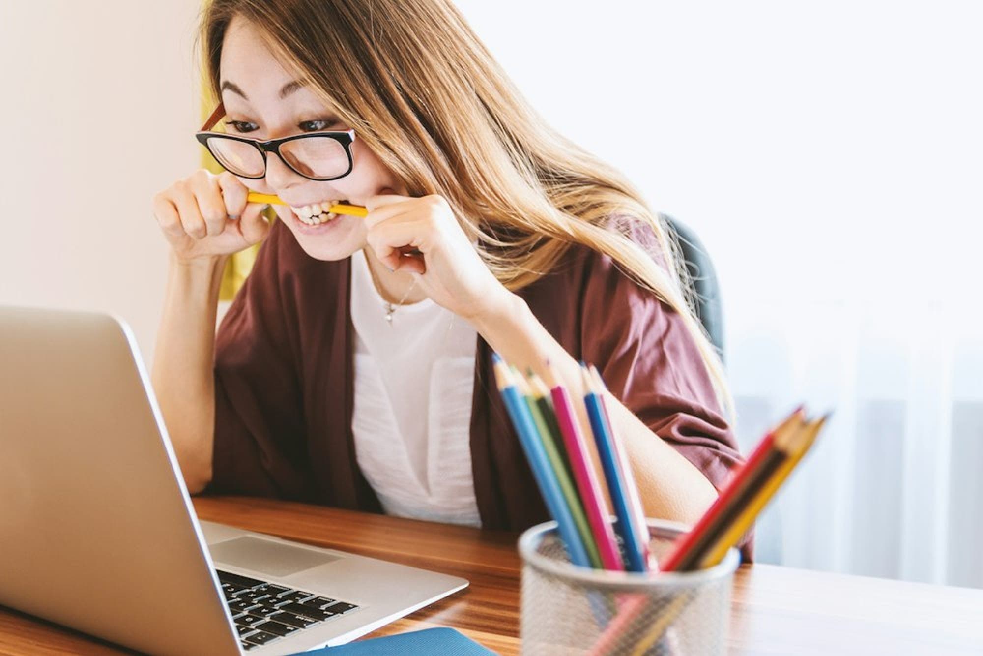 Schülerin am Laptop mit Farbstiften
